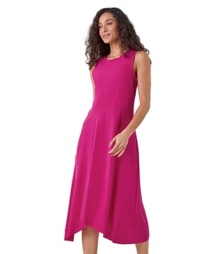 Asymmetric Sleeveless Stretch Midi Dress from Roman. Keep your style simple and chic this season with this sleeveless Dusk midi dress. Cut from a comfortable stretch jersey fabric, this dress features a modest round neckline and a Summer ready sleeveless style. Cut in a flattering fit and flare shape with a floaty asymmetrical hemline, this dress is designed to pull-on for quick and easy dressing. Falling to a modest midi length with a unique diagonal dropped waist, this dress can be dressed up or down to suit any occasion. Add sandals and sunnies for a simple Summertime look!
