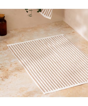 Elevate your bathroom with the Hebden Striped Cotton Bath Mat, crafted from 100% cotton terry for an irresistibly soft feel underfoot. Combining a timeless striped design with versatile contemporary shades, it brings a perfect balance of classic and modern style to your space. Designed to create a cool, calming atmosphere, this bath mat promises more than just style—it enhances your sense of comfort and wellbeing. Durable and naturally breathable, it offers practicality to match its beauty, making it an essential finishing touch to your home environment.