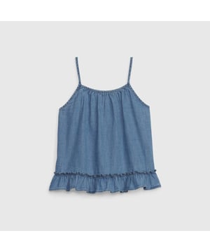 Sleeveless blouse for girls made of light denim fabric, ideal for warm days.

 It features adjustable thin straps and a gathered round neckline, which provide a delicate and fluid touch.

 The design includes a decorative ruffle at the hem, adding a feminine and casual touch.

 At the back, it features an elegant overlay with button closure, giving it a fun and dynamic look.

 Perfect to combine with shorts or skirts, this blouse is ideal for a casual and fresh look.
 Composition: 100% Cotton
 Care:
- Machine wash cold.
 - Use similar colors in the wash.
 - Avoid the use of bleaches.
 - Dry at low temperature in the dryer.
 - Iron at low temperature.
 - Do not dry clean.