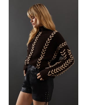 Oversized fit for a relaxed, contemporary silhouette
        Striking whipstitch detail in a contrasting hue
        Long sleeves with dropped shoulders for added comfort
        High neck design for extra warmth and style
        Versatile piece suitable for various casual occasions
    
    This Warehouse jumper radiates confidence with its bold whipstitch detailing and oversized fit. The contrasting stitching creates an eye-catching pattern that runs vertically down the garment, adding visual interest and texture. Perfect for those who appreciate edgy yet feminine style, this jumper can be effortlessly styled for various casual events. Pair it with leather shorts and ankle boots for a night out with friends, or throw it over your favourite jeans for a cosy family gathering. The high neck and long sleeves offer warmth without compromising on style, making it an ideal choice for transitional weather. For a more relaxed look, team it with wide-leg trousers and trainers. This versatile piece allows you to express your unique style while maintaining comfort, embodying the essence of contemporary British fashion.