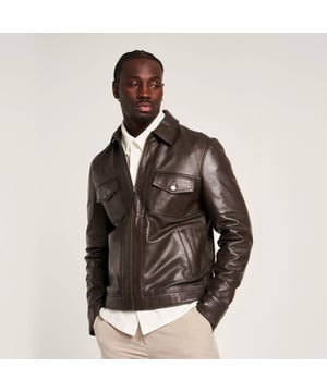 Introducing the Barneys Originals Brown Leather Harrington jacket - a timeless piece crafted for the modern adventurer. With its rich brown hue and classic Harrington silhouette, this jacket exudes rugged sophistication. Perfect for any occasion, whether you're exploring the city streets or unwinding in the countryside, it's the epitome of versatile style and enduring quality.