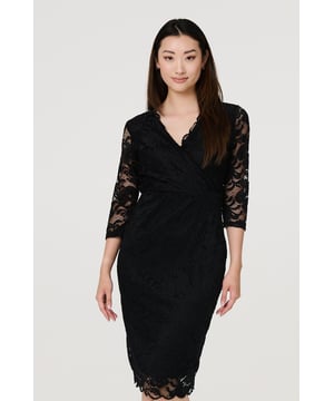 Every closet needs a timeless black dress like this lace wrap front look. With a v-neck, a faux wrap front, 3/4 sheer lace sleeves and a fitted silhouette. Style with pointed heels and a matching bag for an effortless evening look perfect for every event.
