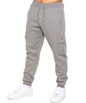 Experience superior comfort and style with Enzo Men's Regular Fit Cargo Joggers! Crafted with a brushed back inner fleece lining, these joggers are designed to keep you cozy all day long. Perfect for casual wear, they feature convenient 2 side slash pockets and 2 cargo pockets, providing ample storage space for your essentials. Stay on-trend with the cuffed leg design, offering a modern silhouette and added comfort.