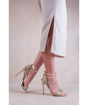 Step out in style and sophistication with our High Heels with Threaded Wide Straps. These stunning heels are designed to elevate your outfit and add a touch of glamour to every step.
Key Features:


Threaded Wide Straps: The unique threaded wide strap design adds an elegant and polished touch to these heels, making them the perfect option for those who want to make a fashion statement.

Breathable Design: The open toe front and heel provide breathability, ensuring your feet stay cool and comfortable even on warmer days.

Comfortable Height: The high heel provides stability and support, while the cushioned insole ensures all-day comfort. Walk confidently knowing that your feet will stay comfortable, no matter where the day takes you.

Versatile Style: These heels are versatile and can be paired with a variety of outfits. Dress them up with a skirt or dress for a night out on the town, or dress them down with jeans for a more casual look. The options are endless.

Specifications:


Material: Faux Leather

Strap Detail: Threaded wide straps add a unique and stylish element

Closure: Buckle closure for a secure and adjustable fit

Sizes: Multiple sizes available

Colours: Available in various options

Elevate your style and make a statement with our High Heels with Threaded Wide Straps. Combining fashion and functionality, these heels allow you to showcase your individuality while enjoying all-day comfort. Step out with confidence and embrace your inner trendsetter.
Where's That From crafts footwear with care, focusing on unique designs that offer the latest trends, luxury comfort, and unparalleled quality. Follow our social media accounts for daily inspiration on putting together outstanding looks.