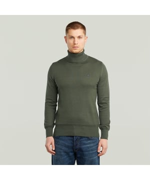 Ribbed turtle neck. Ribbed finished cuffs and waist. Structure knit above the cuffs and waist. G-Star RAW embroidery at the chest. Information label at the lower front- remove hand stitch to detach. No closure. A knitted structure created out of fine yarns. The material mix in the yarns adds to a comfortable feel. Knitted turtle neck sweater Core features a straight fit with a ribbed, raised collar. Also the cuffs and waist are created out of a ribbed knit. A different structure is knitted straight above. The G-Star RAW embroidery at the chest signs it off. 50% Organic cotton 50% Polyacrylic. Built-in stretch