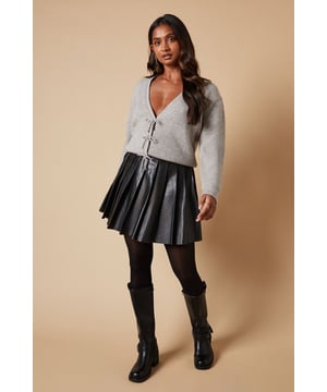 Elegant V-neck design for a flattering neckline
        Charming crystal bow buttons add a touch of sparkle
        Ribbed knit texture for added visual interest
        Versatile cropped length perfect for layering
        Long sleeves for warmth and style
    
    Embrace feminine charm with this Crystal Bow Button Down Jumper from Oasis. The delicate crystal bow buttons lend a touch of whimsy to this otherwise classic piece, making it a versatile addition to your wardrobe. Style it with a pleated skirt and opaque tights for a chic daytime look, or pair it with tailored trousers for a more polished ensemble. The cropped length works wonderfully with high-waisted bottoms, creating a balanced silhouette. For casual outings, throw it over a floral dress and add ankle boots for an effortlessly stylish look. This jumper is perfect for family gatherings, brunch dates, or casual Fridays at the office. Its soft knit fabric ensures comfort, while the ribbed texture adds a subtle sophistication to your outfit.