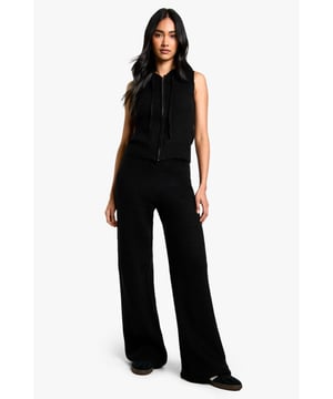 Sleeveless knit hoodie and wide-leg trouser set
        Hooded neckline with adjustable drawstring
        Ribbed knit texture for added interest
        Wide-leg trousers for a relaxed silhouette
        Versatile two-piece design for mix-and-match styling
    
    Embrace laid-back luxury with this chic co-ord set from Boohoo. The sleeveless knit hoodie offers a contemporary twist on athleisure, while the wide-leg trousers create a flowing, elongated silhouette. Perfect for casual outings or lounging at home, this set can be dressed up or down with ease. Pair with trainers and a crossbody bag for a trendy daytime look, or style with heeled mules and statement earrings for an evening out with friends. The ribbed knit texture adds a tactile element, making this set both comfortable and stylish. For cooler days, layer a long-sleeved top underneath the hoodie or throw on an oversized denim jacket. The versatility of this co-ord allows for endless styling possibilities, making it a must-have addition to your wardrobe.