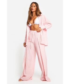 Seersucker fabric for a textured, breezy feel
        Wide-leg design for effortless comfort
        Striped pattern adds a classic beach-ready look
        High-waisted fit with elasticated waistband
        Lightweight material perfect for warm weather
    
    Make a splash in these chic striped seersucker beach trousers from Boohoo. The wide-leg silhouette offers a relaxed fit that's ideal for strolling along the shore or lounging by the pool. The high-waisted design flatters your figure, while the lightweight fabric keeps you cool under the sun. Style these versatile trousers with a matching crop top for a coordinated look, or pair with a simple white vest for a more casual vibe. Whether you're jetting off to a tropical destination or enjoying a staycation, these trousers are a must-have for your summer wardrobe. Dress them up with wedges and statement jewellery for beachside cocktails, or keep it laid-back with sandals and oversized sunnies for a day of seaside exploration.
