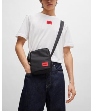 A minimalist reporter bag with an adjustable strap by HUGO. Featuring a rubber logo patch, this accessory comes in matte fabric with a fine structure.

Length: 15,0 cm
Width: 5,0 cm
Height: 20,0 cm
Fastening top: Zip closure
1 inside open pocket
Hardware finishing: Brushed gunmetal hardware
Packaging: Dust bag

100% Polyester (recycled) , Lining: 100% Polyester, Facing: 100% Polyamide
 
50492693
 