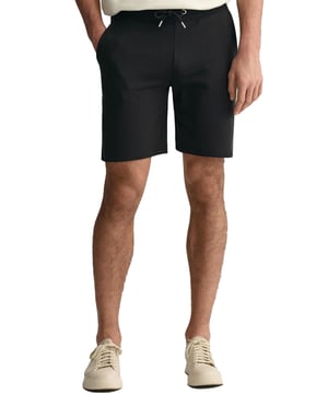 These classic sweat shorts are crafted from a soft cotton blend and tailored for a regular fit. Featuring a ribbed waistband for enhanced comfort, the design includes two front pockets, a single back pocket, and a drawstring waist. Completing the look, the shorts are adorned with a small-scale shield graphic embroidered on the left leg.