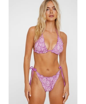 Delicate lace fabric with intricate floral pattern
        Halterneck triangle top with ruffle detailing
        Tie-side bikini bottoms for adjustable fit
        Two-tone design for added visual interest
        Flattering cut to enhance feminine silhouette
    
    Make a splash this summer with NastyGal's captivating Lace 2 Tone Ruffle Triangle Bikini Set. This alluring swimwear piece combines romantic lace with a daring cut, perfect for those who want to turn heads at the beach or poolside. The halterneck top features charming ruffle detailing, adding a touch of playfulness to your look. The tie-side bottoms allow for a customised fit, ensuring comfort throughout your sun-soaked adventures. Ideal for a tropical getaway or a day at the lido, this bikini set is versatile enough to take you from lounging by the pool to sipping cocktails at a beachfront bar. Layer with a sheer kaftan and slip-on sandals for a chic resort ensemble, or pair with high-waisted shorts and oversized sunglasses for a trendy beach club look. Whatever your summer plans, this NastyGal bikini set is sure to be your go-to choice for sultry sophistication.
