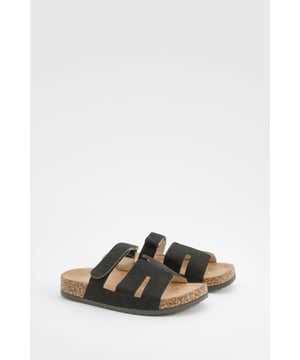 Stylish cut-out detail for a unique look
        Flat heel between 0 and 2cm for all-day comfort
        Cork-effect footbed for a natural aesthetic
        Adjustable buckle strap for a customised fit
        Versatile design suitable for various casual occasions
    
    Step into comfort and style with these eye-catching slides from Boohoo. The distinctive cut-out detail adds a contemporary twist to a classic silhouette, making these sandals a standout choice for the fashion-forward woman. Perfect for casual outings, family gatherings, or leisurely strolls, these slides offer both comfort and flair. The cork-effect footbed not only provides a natural, earthy look but also ensures a comfortable base for your feet. Pair them with cropped jeans and a breezy blouse for a chic daytime ensemble, or wear them with a flowing maxi dress for a relaxed evening look. The adjustable buckle strap allows for a personalised fit, ensuring these slides will be your go-to footwear for various casual events. Embrace the laid-back yet trendy vibe these slides offer and make them an essential part of your summer wardrobe.
