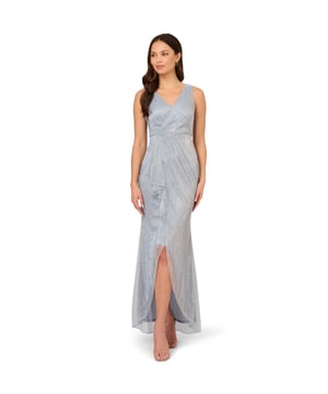 Turn on the sparkle at your next event in this metallic evening gown. This formal dress features a sleeveless surplice bodice, draped and ruffled details that fall from hip to hem, and a split skirt. Partially lined and crafted from metallic threaded mesh, this sleeveless gown has a sheer skirt that shows off the legs at the front. A zipper back closure completes this ethereal look. Statement earrings and metallic heels are the perfect accessory to add further polish to this metallic dress.