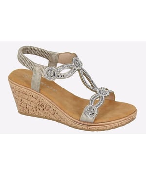 Elevate your footwear collection with these stunning wedged sandals that effortlessly fuse style and comfort. 
 Crafted with a synthetic upper embellished in jewels, these Ora Cipriata Sandals deliver a holiday aesthetic and bring a touch of glamour to your outfits. 
 These sandals feature a plush PU lining with the padded microfiber sock providing soft cushioning with every step, ensuring all-day comfort, while the elasticated sling-back design offers a sung fit.
 Completed with a durable cork wedge outsole, these sandals are bound to turn heads, whether you're strolling along the beach or stepping out for a night on the town. 
 - Synthetic upper 
 - PU lining 
 - Padded micro fibre sock 
 - Jewelled embellishments 
 - Elasticated sling back design 
 - Durable cork wedge outsole