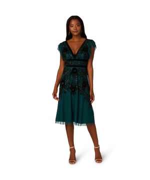 Elevate your evening attire with our stunning midi dress, crafted from an exquisite all-over beaded mesh knit fabric. The V-neckline at both front and back creates a flattering silhouette, complemented by delicate flutter sleeves for a touch of femininity. Velvet trim detailing at the neckline and waist adds luxurious contrast, while the zipper closure at the centre back ensures a seamless fit. Perfect for formal occasions or special events, this dress effortlessly combines elegance and allure, making it a standout choice for any sophisticated affair.
