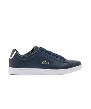 These trainers offer a perfect blend of classic style, modern design, and the renowned quality that Lacoste is known for. 

Featuring a navy blue colorway, these trainers exude timeless elegance and versatility. The rich blue hue adds a sophisticated touch to your outfit, allowing you to effortlessly transition from casual to more dressed-up occasions. The clean and sleek silhouette enhances the overall aesthetic, making them a stylish choice for any fashion-conscious woman.

Crafted with attention to detail, the Lacoste Carnaby Evo BL 1 SPW Trainers boast a durable leather upper that not only looks luxurious but also ensures long-lasting wear. The premium leather construction offers a smooth and supple feel, providing comfort and flexibility for all-day wear.

Designed with both style and comfort in mind, these trainers feature a lace-up closure that allows for a secure and personalized fit. The padded collar and tongue provide additional cushioning and support, ensuring maximum comfort throughout the day. The low-top design offers freedom of movement, making them suitable for various activities.

The Lacoste Carnaby Evo BL 1 SPW Trainers proudly display the iconic Lacoste crocodile logo on the side, symbolizing the brand's heritage and commitment to quality. This logo serves as a mark of authenticity and adds a touch of sporty elegance to the overall design.

Whether you're running errands, meeting friends, or embarking on a casual day out, these trainers offer both style and functionality. Pair them with jeans, skirts, or dresses to effortlessly elevate your ensemble.

Indulge in the classic charm of the Lacoste Carnaby Evo BL 1 SPW Women's Navy Blue Trainers. With their timeless design, durable construction, and comfortable fit, these trainers are a must-have for women who value both fashion and quality.
