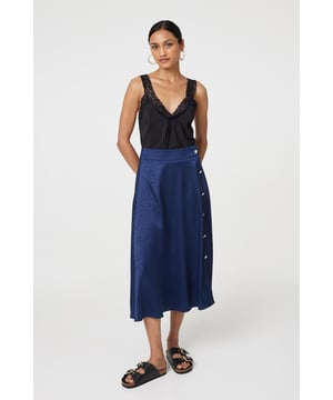 This elegant skirt has a silky satin texture with a flattering a-line cut. It fastens with button details and has a high waist fit, with a midi length hem. Tuck your favourite t-shirt, top or jumper into the waistband for an elevated casual look.