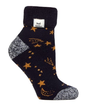 Looking for that cosy touch to complete your downtime at home? Meet our Ladies Lite Lounge Socks with a delightful Turnover Top - the little luxury you didn't know you needed!Brought to life from our Lounge Collection, these thermal socks were tailored with home-lovers in mind. Drawing inspiration from the calming hygge lifestyle in elements of Scandinavian tradition, these socks are your ticket to relaxing, reviving, and simply unwinding in your special space at home.Worried about slick wooden or tiled floors? Worry not! These socks were made to keep you steady with inherent non-slip grippers on each sole. These cuties bring you the much-loved warmth of our popular Lite Heat Holders slipper socks, all in a fashionable yet practical ankle-length design.But it's not just about the socks. These gems arrive stylishly wrapped with a ribbon and a blank tag, all ready for your personalised message. Be it Christmas, birthdays or 'thinking-of-you' days, these socks hold the warmth of an ideal gift.The Lounge Socks are one size Ladies 4-8 UK and made from 94% Acrylic, 5% Polyester, and 1% Elastane. They are available in 4 colour options: Silver Dots, Cabernet Dots, Navy/Gold Star and Ivory/Cabernet Stars. They are machine washable.