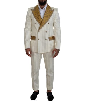 100% Authentischer Dolce & Gabbana Anzug  
Farbe: Off-White und Gold  
Stil: Doppelreihiger 2-teiliger Anzug; beinhaltet Blazer und Hose  
Verschluss: Zwei-Knopf-Verschluss  
Passform: Slim Fit  
Zwei Innentaschen  
Ein offener Schlitz hinten  
3-Wege-Hosenreißverschluss  
Hergestellt in Italien  
Material: 70% Baumwolle, 15% Polyester, 13% Seide, 1% Nylon, 1% Metall  
Futter: 15% Viskose, 85% Seide