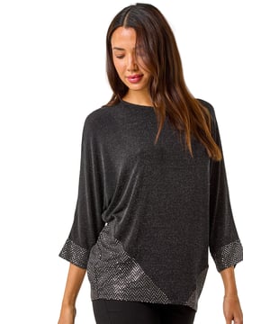 Contrast Sparkle Stretch Top from Roman. Sparkle and shine this Autumn/ Winter in this glamorous contrast sparkle top. Crafted from a unique brillo sparkle fabric, this top features a round neck and chic 3/4 sleeves for a sophisticated touch. With a flattering below hip length and contrasting baby disco sparkle fabric at the hem and sleeve cuff, this top is perfect for adding some sparkle to your evening ensemble. Pair with pleather trousers and heeled boots for a party ready outfit that is sure to turn heads!