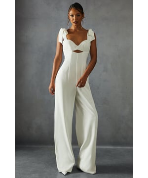 Striking bow shoulder detail for a feminine touch
        Flattering sweetheart neckline with alluring cut-out
        Wide leg silhouette for a dramatic, flowing look
        Square back design adds a modern twist
        Floor-length style perfect for formal occasions
    
    Make a statement at your next special event with this captivating wide leg jumpsuit from Misspap. The eye-catching bow shoulders lend a romantic flair, while the sweetheart neckline and subtle cut-out detail create an alluring silhouette. The wide-leg design flows gracefully to the floor, ensuring a dramatic entrance wherever you go. Style this showstopper with strappy heels and statement earrings for a red carpet-worthy look. Perfect for weddings, galas, or any occasion where you want to turn heads, this jumpsuit offers a fresh alternative to traditional evening wear. The square back adds a contemporary edge, making this piece a versatile addition to your formal wardrobe. Embrace your inner fashionista and let this jumpsuit be the centrepiece of your next unforgettable night out.