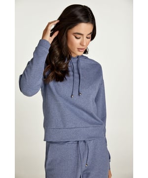 Esta sudadera con capucha de color índigo melange está confeccionada en tejido de punto elástico. Una corbata del mismo tejido recorre el interior de la capucha y hay dos topes de metal plateado en los extremos. Hay detalle de costura en los hombros. Tiene manga larga con puño. La sudadera tiene un dobladillo de 7 cm. La prenda tiene un estilo holgado y relajado.