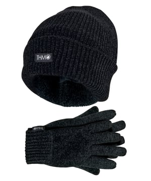 Sometimes a pair of gloves or a comfy hat just isn’t enough to keep the cold out which is why we’ve decided to combine our super warm Thinsulate lined THMO Hat & Gloves into the ultimate thermal set! Below are some more details about each part of the set: Ladies THMO Beanie The hat has a turnover cuff, so you can wear the hat cuff turned over or you can straighten the hat out to give you some extra length. On the cuff is the black THMO badge stitched into the front of the hat. The cuff also hugs the side of your head firmly so that heat can not escape though the sides. Ladies THMO Gloves The inner lining is made with 3M Thinsulate lining. Thinsulate is well known for keeping your hands warm and is considered one of the most effective linings. The ribbed cuff on the gloves is tight enough to stop the warm air escaping but not too tight to be uncomfortable. The THMO logo badge also hangs from the cuff, separating your glove fashion from the rest. Both hat and gloves in this set are made from 100% Chenille. It is a super soft material and is known to be softer than acrylic. It also gives off a luxuriously plush look, a winter fashion accessory to be proud of. It is also a good thermal insulator, holding warm air close to your body and trapping the heat that is generated by your body. This set is Ladies One Size and available in 3 Colour options: Black, Red & Light Grey. They are 100% Acrylic and are Machine Washable.