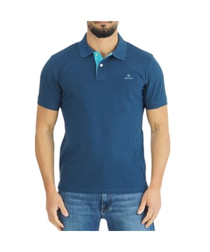 A preppy classic –with a twist. Featuring contrasting colors on the backside of the collar and placket, this short sleeved polo shirt brings an unexpected pop of colour to any preppy outfit.

GANT Men's Polo Shirt
Style Code: 2052003
Made in Turkey
96% Cotton 4% Elastane
Regular Slim Fit
GANT New Daimond Logo Embroidery at Chest
Polo Placket with Contrasting Color
Stretchable Rich Cotton Pique Fabric
Flatknit Collar with Contrast Colour
Dual Button Front Placket
Short Sleeve
Machine Wash According to Instructions on Care Label