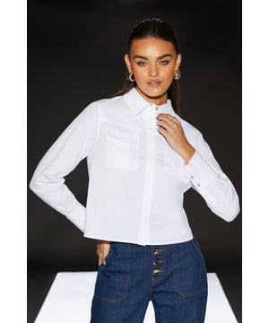 Cropped boxy silhouette for a modern, edgy look
        Collared neckline with button-down front
        Long sleeves with buttoned cuffs
        Utility-inspired design with clean lines
        Versatile cotton poplin fabric for comfort and style
    
    Make a bold statement with this cropped boxy utility shirt from the RUNWAY 1.8.1.8 collection. The clean lines and modern silhouette project confidence and style, perfect for the fashion-forward woman. Pair it with high-waisted wide-leg trousers, as seen on the model, for a chic daytime ensemble. The versatile design allows for endless styling options - tuck it into a midi skirt for a family gathering or layer it over a fitted top for a casual brunch with friends. The cotton poplin fabric ensures comfort throughout the day, while the utility-inspired details add an edgy twist to your look. Whether you're running errands or meeting mates for coffee, this shirt will keep you looking effortlessly stylish. Accessorise with statement earrings and a sleek ponytail to complete your fashion-forward outfit.