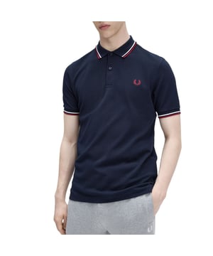 The Twin Tipped Fred Perry Polo Shirt by Fred Perry is a short sleeved polo shirt that has been made from Fred Perry's classic cotton piqué, in a contemporary adaptation of Fred's famous streamlined fit. Available in a diverse range of colourways - each with their own unique story. Featuring the signature Fred Perry wreath logo to the chest and twin tipping to the collar and cuffs.