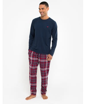 Lounge in comfort with this pyjama set from Threadbare. This two-piece set consists of a long sleeve, round neck top with raglan sleeves and long flannel check bottoms that have an elasticated waistband and branded drawcords. Perfect for lounging at home or bedtime.