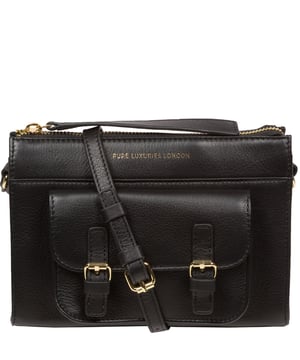 Handcrafted from Nappa leather, the 'Monica' cross body bag from the Pure Luxuries London Marylebone Collection elevates this classic design. A spacious main compartment is secured under a zip-over top which is lined with 100% cotton for a luxurious feel. Two slip pockets on the interior of the bag provide additional storage space - ideal for maintaining an organised accessory. Complementing the interior storage is a stylish pocket secured with a press-stud fastener made to look like a buckle reminscent of the classic satchel design. Gold-coloured metal fittings and zips adorn the bag alongside the slim and adjustable leather strap with a maximum drop length of 65cm. The Pure Luxuries logo is embossed in gold foil for a beautifully simple finishing touch.