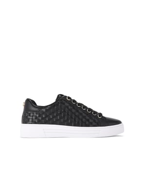 The Carvela Daze Weave trainer features a black upper with woven sides. The hardware is gold with embossed foil logo on the tongue.