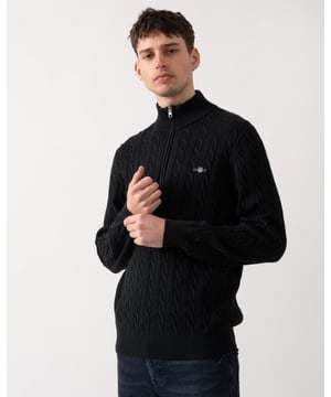 Designed in cotton with an all-over cable knit structure, this soft sweater has a regular fit and sporty half-zip collar. A preppy essential, it is detailed with our iconic GANT shield embroidered at the chest, and ribbed endings at the neck, hem and cuffs.
Regular fitHalf-zip collarCable knit structureGANT graphic embroidered at chest
 
100% Cotton
 