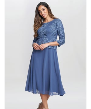 Elegant dress in a mock top and skirt style. This dress features a sequin and embroidered bodice and a soft flowing chiffon skirt.