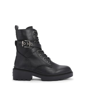 The Boulder Combat ankle boot features a black textured upper with classic lace tie as well as buckled ankle strap. There is a Icon C stud in gunmetal at the back of the ankle.