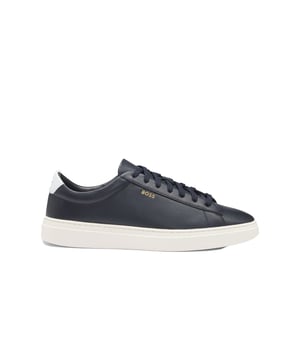 Boss Kieran_tenn_bu Trainers in Navy
Elevate your everyday style with these sleek and sophisticated lace-up trainers from BOSS Menswear. Crafted from premium polished leather, these low-profile shoes boast a refined look with subtle logo details for a touch of understated luxury.

 
Key Features:

Sleek Design: Low-profile silhouette with a polished leather finish for a refined look.  
Comfortable Fit: Fully lined for added comfort and support.
Durable Construction: Built to last with a rubber sole for excellent traction.
Sustainable Materials: A minimum of 60% of the leather used has been sourced from certified tanneries, reflecting BOSS's commitment to responsible production.
Upper: 100% Cow skin
Lining: 100% Polyester, 60% Polyester, 40% Polyurethane
Sole: 100% Rubber
Innersole: 100% Polyester