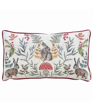 An adorable cushion featuring three posing winter hares among winter foliage and a toadstool, set on a fresh white background. The hand painted watercolour design is printed on polylinen fabric, with a plush plain red velvet reverse, contrasting piped trim and zip fastening. Ideal for bringing a touch of nature to your home.