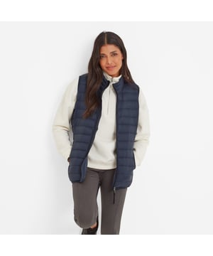 Designed to keep your body warm and your arms free for a full range of movement, our Gibson Women's gilet is wind resistant, ultra warm and velvety soft. Ideal to wear as a mid-layer under a waterproof on wet days, or as a cosy lightweight bodywarmer over a jumper when it's dry,  Gilson is quilted in a buttery-soft fabric that feels velvety against your skin and the high tech insulating filling, made entirely from recycled plastic bottles, makes it ultra warm. There is elasticated binding at the hem to stop draughts, two handy lower pockets with elasticated binding and a cosy neck to snuggle into. Designed by our team in West Yorkshire, this versatile puffa style gilet comes in a choice of colours inspired by nature that work for every season. The finishing touch is a discreet, tonal TOG24 logo printed on the chest.