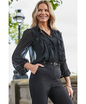 This one works as hard as you doAll-over spot print that's always on-trendGorgeous ruffle detail takes it from desk to dinner We've kept the sleeves sheer and added a cami for coverage Longline hem you can wear loose or tucked inIt looks so chic with cigarette trousers and courts