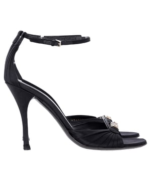 VINTAGE, RRP AS NEW
Elevate your evening ensemble with the Gucci Crystal-Embellished Open-Toe Sandal Heels in luxurious black satin. These stunning heels feature a captivating crystal embellishment that adds a touch of sparkle and glamour, perfect for any special occasion. The open-toe design elegantly showcases your pedicure, while the delicate straps provide a secure fit and enhance the overall allure of the shoe. Crafted from high-quality satin, these sandals not only look fabulous but also offer comfort for all-night wear. Pair them with your favorite cocktail dress or tailored jumpsuit to create a head-turning look that embodies the sophistication of Gucci.

 Gucci Crystal-Embellished Open-Toe Sandal Heels in Black Satin

Condition: Very good
Signs of wear: Minor markings, Lightly used but very well maintained. Minor mark at soles & creasing, light scuffing at the soles and heels.
Packaging: None
Color: Black
Material: Satin | satin
Size: IT38.5/FR39.5/UK5.5/US8.5
Measurements: Heel height: 11; Insole length: 25,5
SKU: NAPPUITSH397907W