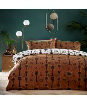 It’s dusk in Morocco and the lively desert monkeys have come out to play. They roam freely around the tall palm trees, under a clear, darkening moonlit starry sky which turns them into shadowy silhouettes. Exuding the amber heat of evenings in North Africa, this duvet cover set brings both warmth and character to your bedroom. The reverse offers a clean, white contrast design, if a more neutral look is required. Perfect to be accompanied by the Dusk Monkey range of cushions for fabulous matching style!