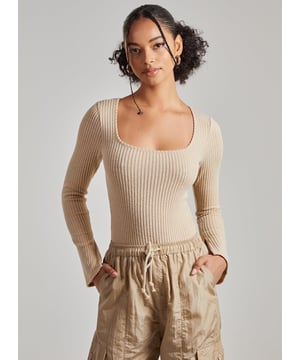 Fitting very closely to the body for an all-round sassy look, this slinky little number is a must have Bodysuit!