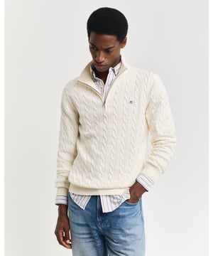 Designed in cotton with an all-over cable knit structure, this soft sweater has a regular fit and sporty half-zip collar. A preppy essential, it is detailed with our iconic GANT shield embroidered at the chest, and ribbed endings at the neck, hem and cuffs.
Regular fitHalf-zip collarCable knit structureGANT graphic embroidered at chest
 
100% Cotton
 