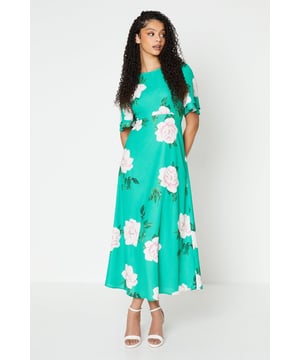 Vibrant floral print adorns this woven midi dress
Flattering round neckline and flutter sleeves
Relaxed fit through the bodice
Midi length hits below the knee
woven fabric with a lightweight feel

Embrace the season's botanical trend with this eye-catching floral midi dress. The vibrant print and flutter sleeves exude a feminine charm, perfect for daytime occasions like brunches or family gatherings. Style it with trainers or sandals for a relaxed yet polished look that transitions seamlessly from day to night.