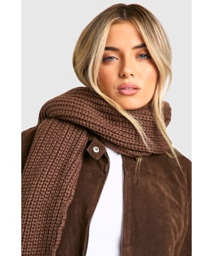 Chunky ribbed knit texture for added warmth and style
        Generous length for versatile wrapping and draping
        Soft and cosy blend of acrylic and wool
        Classic rectangular shape for easy styling
        Timeless design suitable for various outfits and occasions
    
    Wrap yourself in comfort and style with this long ribbed knit scarf from Boohoo. Perfect for those chilly days, this versatile accessory adds a touch of cosiness to any ensemble. The chunky ribbed texture not only provides extra warmth but also creates a visually appealing pattern that complements a range of looks. Style it with a leather jacket and skinny jeans for a casual day out, or drape it over a coat for added sophistication during your commute. The generous length allows for multiple styling options - loop it, knot it, or let it hang loose for effortless chic. Ideal for family gatherings, weekend brunches, or casual outings with friends, this scarf is a must-have addition to your autumn and winter wardrobe. Its timeless design ensures it will remain a staple piece for seasons to come, making it a smart investment for the fashion-savvy Boohoo girl who values both style and practicality.