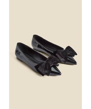 Who needs heels?Luxe patent leather for a hi-shine finish Adorned with a plush velvet bow Wear-forever pointed toe silhouette Flat sole so you can dance the night away We're styling them with wide-leg trousers and a sparkly top