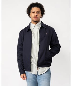 The Cotton Windcheater is a timeless GANT classic that has been a staple for years. It comes in a regular fit with a partly elasticated hem, giving it a fitted silhouette, and sits just above the hips. The jacket is half-lined and features a front zip closure, slanted side welt pockets, and two interior jetted pockets. It's adorned with an embroidered Archive Shield graphic on the chest and includes a GANT branded locker loop at the back.

Regular fit
Above hip length
Two inner and outer pockets
Elastic hem

 Shell - 100% Cotton, Upper Back Lining - 100% Cotton, Sleeve Lining - 100% Recycled Polyester 

7006391
�
�