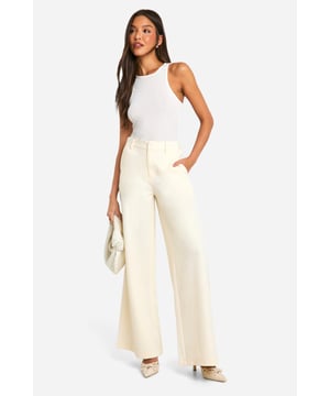 Mid-rise waistband for comfortable fit
        Wide-leg silhouette for a relaxed look
        Front pockets for practicality
        Belt loops for versatile styling options
        Full-length design with floor-skimming hems
    
    Embrace the laid-back charm of these dad-style trousers, perfect for the fashion-forward woman who values both style and comfort. The mid-rise waistband sits comfortably on the hips, while the wide-leg silhouette creates a relaxed and effortlessly cool vibe. Style these versatile trousers with a fitted tank top for a balanced look, or pair them with an oversized blazer for a chic contrast. Ideal for casual outings, from coffee dates to weekend shopping trips, these trousers can be dressed up or down with ease. For a trendy ensemble, team them with chunky trainers and a cropped jacket, or opt for elegant mules and a silky blouse for a more polished appearance. The neutral hue makes these trousers a wardrobe staple that can be mixed and matched with various tops and accessories, ensuring endless styling possibilities for the modern, fashion-conscious woman.
