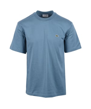 Lacoste Tee in Limestone
Experience the difference with the Lacoste Limestone Tee, a testament to Lacoste's legacy of sportswear excellence since 1933. Crafted from premium Peruvian Pima cotton, this essential tee offers superior comfort and durability. The exceptionally fine, lightweight fabric boasts a subtle sheen and a robust construction, making it a wardrobe staple you can rely on.
 
Features

Premium Pima Cotton: Experience the luxurious feel of 100% Peruvian Pima cotton, known for its superior softness and durability.
Lightweight Fabric: The 130 GSM fabric provides breathability and comfort for all-day wear.
Classic Fit: A regular, straight cut offers a timeless silhouette that looks great on everyone.  Please note: If you are between sizes, we recommend ordering one size up for a more comfortable fit.   
Iconic Branding: The embroidered crocodile on the chest adds a touch of signature Lacoste style.   
Versatile Style
Style code: TH7318